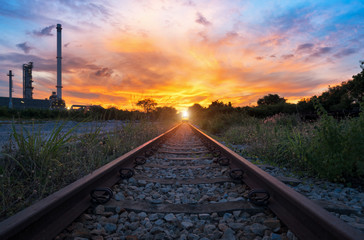 Fototapeta na wymiar View of the railway track at sunset and industrial concept background