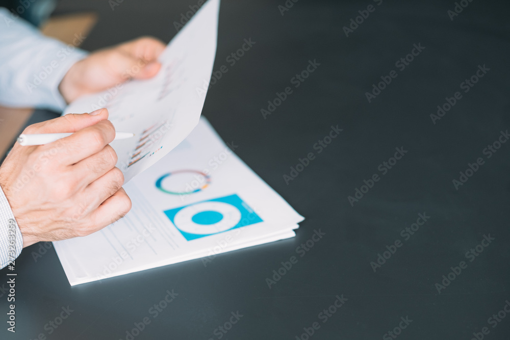 Poster business analytics. cropped shot of man working with graphs and charts. dark desk background. copy s
