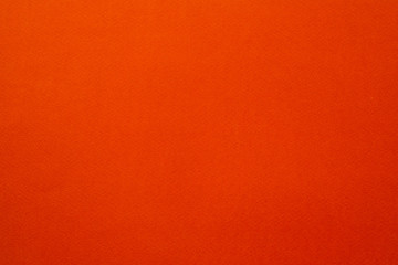 Scarlet orange felt texture abstract art background. Colored fabric fibers surface. Empty space.