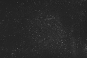 Night sky effect abstract background. White dust and scratches over black surface. Empty space. - obrazy, fototapety, plakaty
