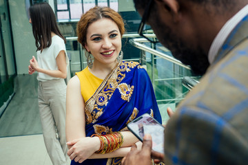 Fototapeta na wymiar Asian business person in multiracial. Diversity business people form by different races, Indian, Malay, Indonesian, Chinese and African in modern room shopping mall