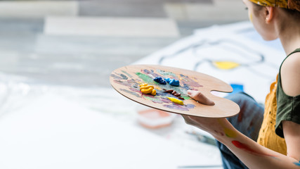 Art therapy and leisure. Cropped shot of lady using acrylic paint palette, creating artworks. Blur...