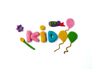 The beautiful kid text has balloon with rocket and paintbrush are made from colorful plasticine clay placed on white background, handmade cute shape dough are decorations