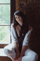Fototapeta premium portrait of stylish, beautiful brunette woman with long hair in black bra and tie in white shirt and white pens