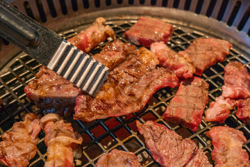 Japanese barbecue cuisine marinated meat slices grilled on coal stove 