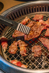 Closeup of Korean barbecue beef slice grilled over charcoal stove
