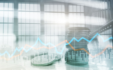Double exposure of city and rows of coins with stock and financial graph on virtual screen. Business Investment concept.
