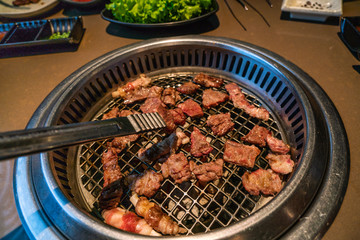 Beef slices grilled on coal stove at Japanese barbecue restaurant