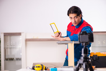 Young contractor recording video for his blog 