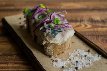 The sandwich with herring fish and onion.