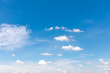 Deep blue sunny sky with white clouds. Blue sky with cloud closeup. White fluffy clouds in the blue sky.
