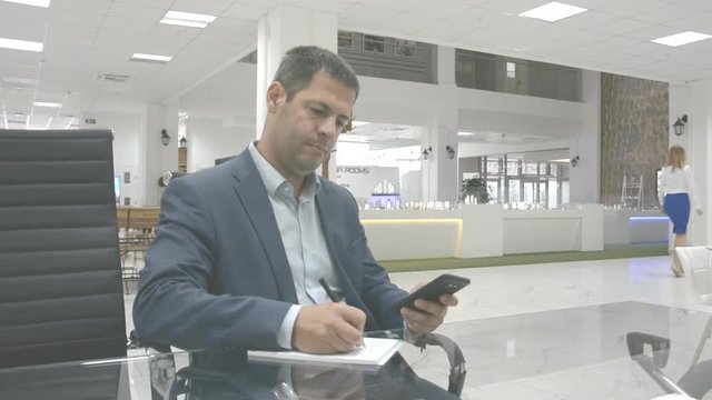 bussines concept Man in the office workplace writing in the note hd footage
