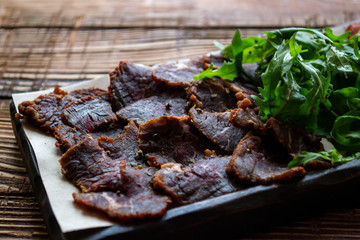 A meat plate on a wooden background.