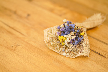 Beautiful dried flower bouquet placed on a wooden table, a bouquet of flowers for congratulations on various occasions.