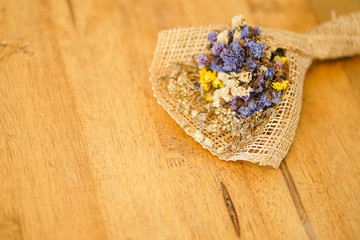 Beautiful dried flower bouquet placed on a wooden table, a bouquet of flowers for congratulations on various occasions.