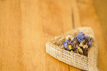 Beautiful dried flower bouquet placed on a wooden table, a bouquet of flowers for congratulations on various occasions.