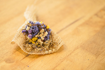 Beautiful dried flower bouquet placed on a wooden table, a bouquet of flowers for congratulations on various occasions.