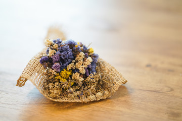 Beautiful dried flower bouquet placed on a wooden table,