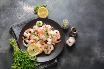 Fresh prawns. Raw shrimps, prawns in a plate on a dark background. Seafood
