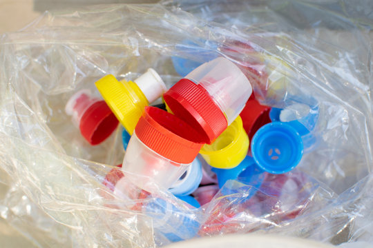 Recycling eco friedly concept background with colorful plastic bottle caps in cellophone package