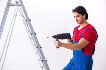 Young handsome contractor working indoors 