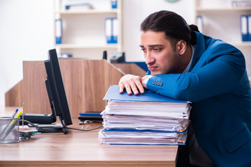 Young handsome businessman sitting in the office 