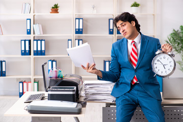 Young employee making copies at copying machine 