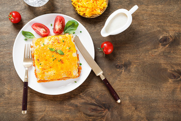 Portion of tasty chicken lasagna with cheddar cheese and bechamel sauce.