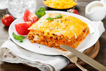 Portion of tasty chicken lasagna with cheddar cheese and bechamel sauce.