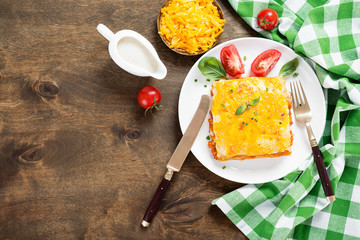 Portion of tasty chicken lasagna with cheddar cheese and bechamel sauce.