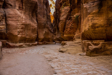 empty narrow path way between steep sand stone rocks inside canyon dry scenic wilderness nature environment 