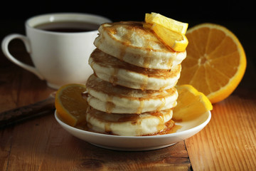 A stack of freshly backed pancakes and a cup of coffee	