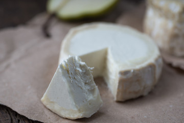Piece smelly camembert cheese on a wooden rustic table