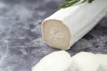 Fresh goat cheese with slices dark marple