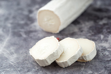 Fresh goat cheese with slices dark marple