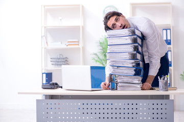 Young male employee unhappy with excessive work