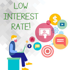 Text sign showing Low Interest Rate. Business photo showcasing Manage money wisely pay lesser rates save higher Man Sitting Down with Laptop on his Lap and SEO Driver Icons on Blank Space