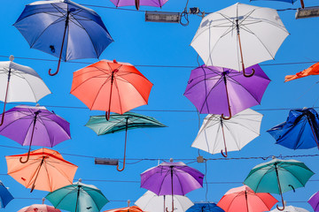 Fototapeta na wymiar hanging umbrellas against the blue sky, walk through the streets of Kaleici, Antalya