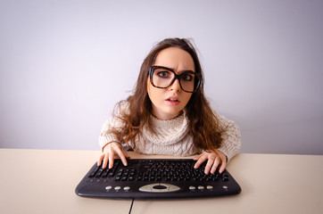 Funny nerd girl working on computer