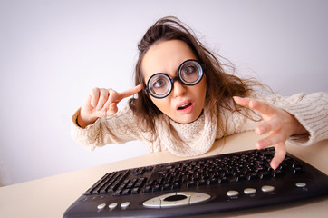 Funny nerd girl working on computer