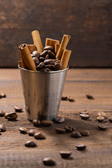 Seeds of aromatic, roasted coffee in a cup with karitsi chopsticks
