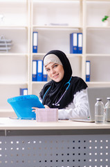 Young doctor in hijab working in the clinic 