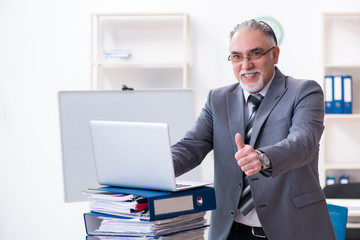 Obraz premium Aged male employee unhappy with excessive work 