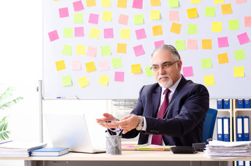 Aged man employee in conflicting priorities concept 