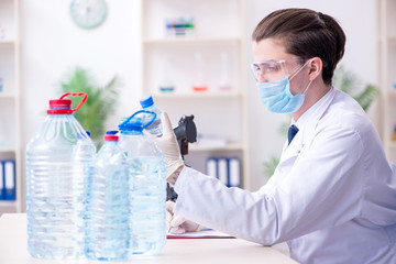 Young male chemist experimenting in lab