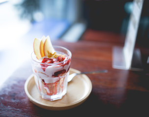 homemade fruit yoghurt with strawberry jam, apple and conflake