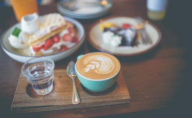 Latte hot coffee with many desert of waffle and chocolate cake