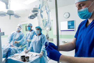 Arthroscope surgery. Orthopedic surgeons in teamwork in the operating room with modern arthroscopic...