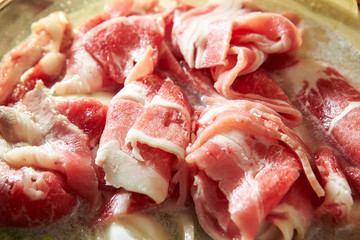 Raw pork in cooking pot 