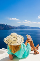 Luxury travel vacation woman looking at view on Santorini island